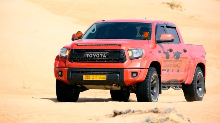 Front view of Toyota Tundra pickup truck navigating a sunny desert landscape.